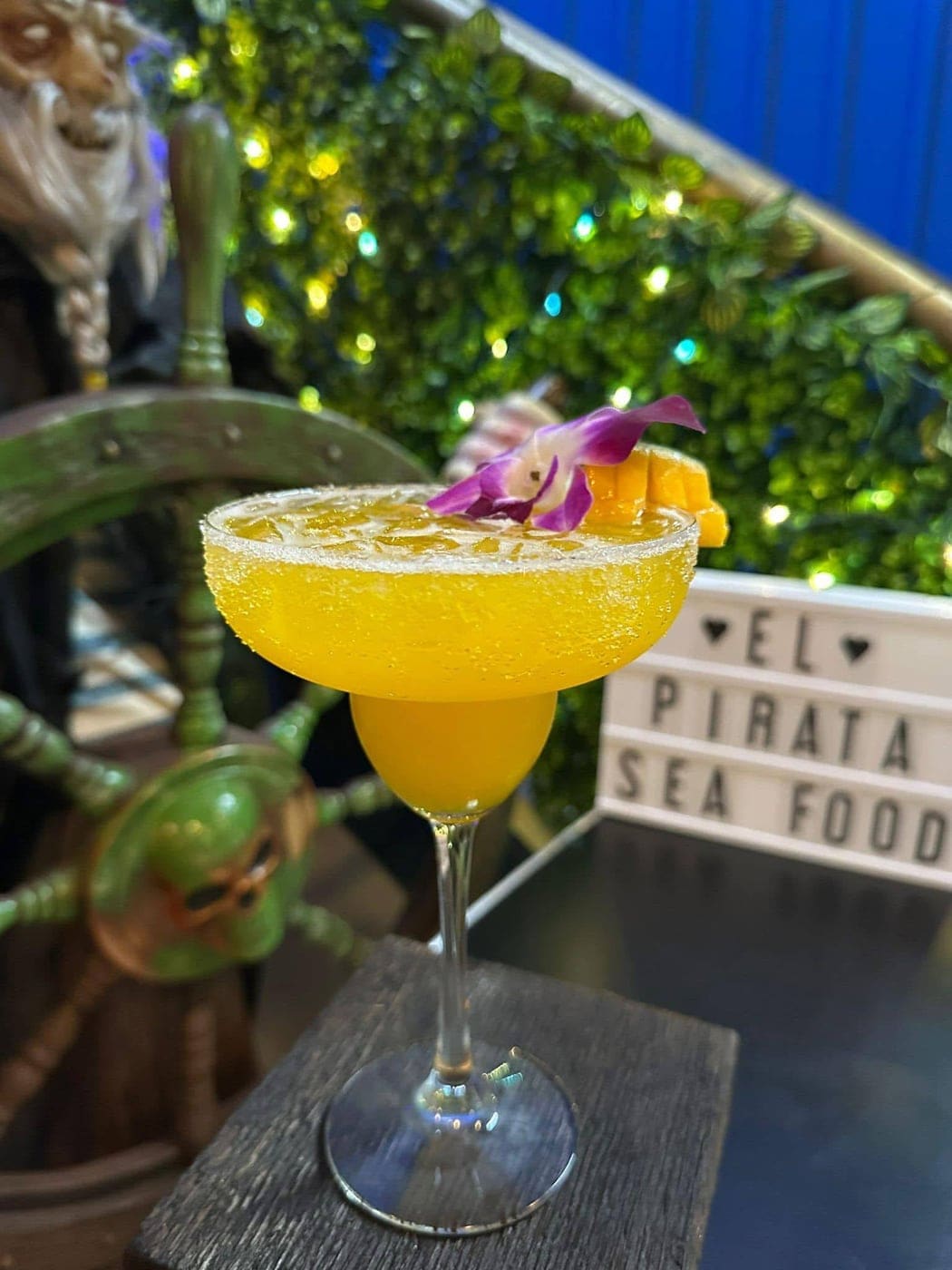 Mango-orange margarita with orchid