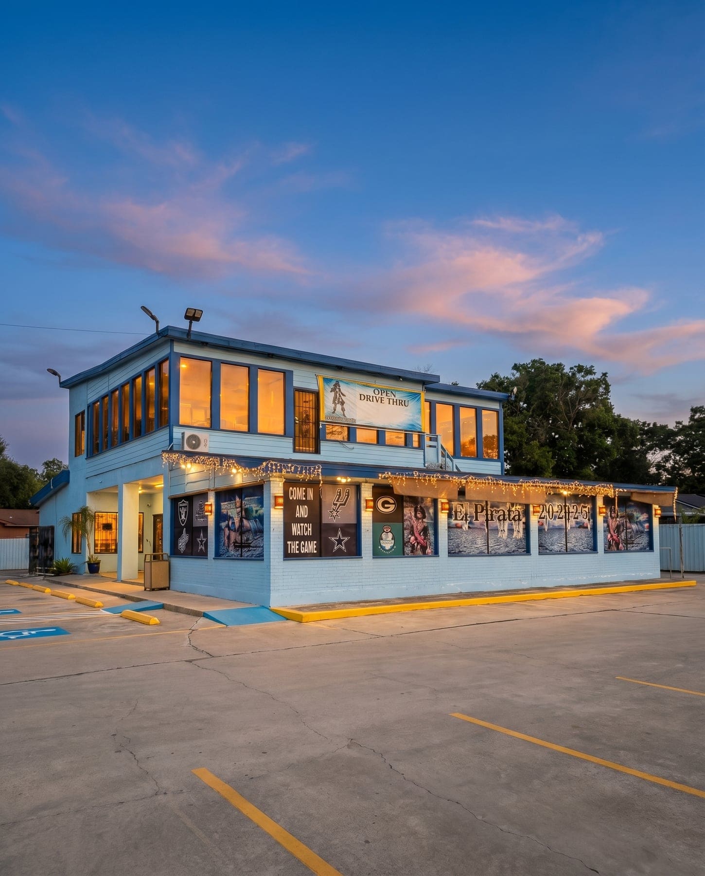 El Pirata's light-blue two-story building at dusk