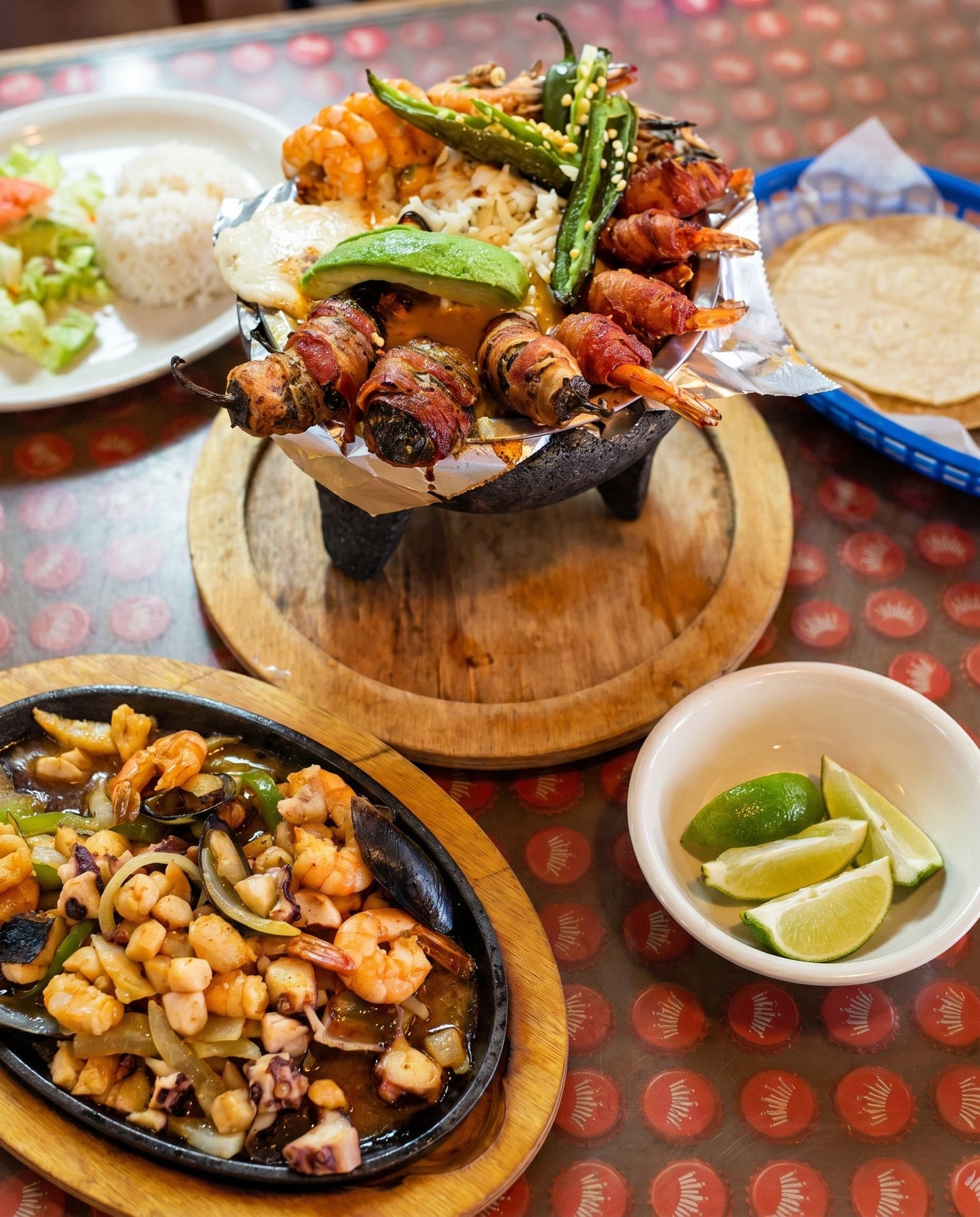 Molcajete with bacon-wrapped shrimp, rice and tortillas