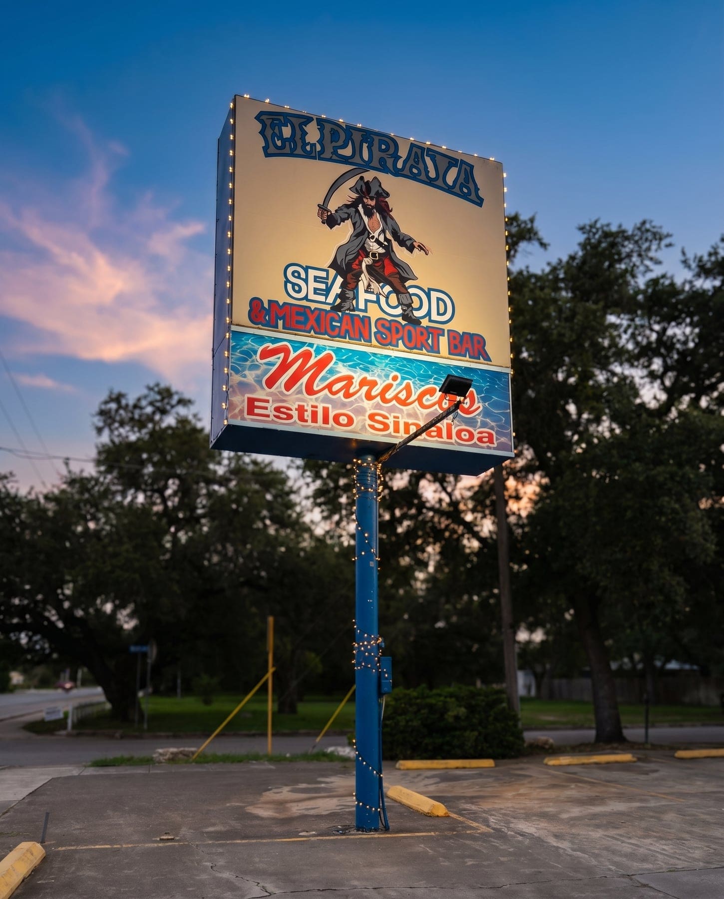 El Pirata pole sign at dusk — Mariscos Estilo Sinaloa